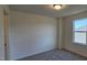 Well-lit bedroom with a window and carpeted floor at 829 Emmer St, Rolesville, NC 27571