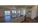 Open concept kitchen with island, hardwood floors, and stainless steel appliances at 829 Emmer St, Rolesville, NC 27571