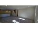 Open loft area with gray carpeting and multiple windows at 829 Emmer St, Rolesville, NC 27571