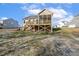 View of the exterior of the home showcasing the backyard, back porch, and deck at 69 Browning Mill Dr, Wendell, NC 27591