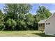 The backyard with mature trees and the screened in porch at 69 Browning Mill Dr, Wendell, NC 27591