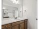 Bathroom vanity with brown cabinets, a large mirror, and a sink at 69 Browning Mill Dr, Wendell, NC 27591