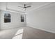 An airy bedroom featuring two windows, a ceiling fan and plush carpet flooring at 69 Browning Mill Dr, Wendell, NC 27591