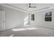 A cozy bedroom with natural light from two windows and plush carpeting at 69 Browning Mill Dr, Wendell, NC 27591