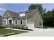 Side view of the home showcasing the garage, siding, and landscaping at 69 Browning Mill Dr, Wendell, NC 27591