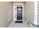 Dark brown front door with sidelights at 69 Browning Mill Dr, Wendell, NC 27591
