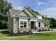 Charming single-Gathering home with stone accents, manicured lawn, and an 'available' sign at 69 Browning Mill Dr, Wendell, NC 27591