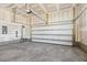 A spacious two-car garage with concrete flooring, ready for vehicles and storage at 69 Browning Mill Dr, Wendell, NC 27591