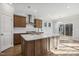 Bright kitchen boasts stainless steel appliances, wooden cabinets and a large island with white countertop at 69 Browning Mill Dr, Wendell, NC 27591