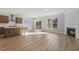 Open concept kitchen and living room area with hardwood floors and a fireplace at 69 Browning Mill Dr, Wendell, NC 27591