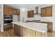 Beautiful kitchen features wooden cabinets, stainless steel appliances and a large island with white countertop at 69 Browning Mill Dr, Wendell, NC 27591
