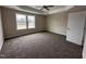 Spacious carpeted bedroom with two large windows and a ceiling fan at 131 Wilderness Trl, Smithfield, NC 27577