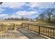 View from wooden back deck looking out at a grassy lawn and other new construction homes in the neighborhood at 55 Browning Mill Dr, Wendell, NC 27591