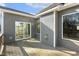 Gray home exterior with sliding glass doors and wooden back porch at 55 Browning Mill Dr, Wendell, NC 27591