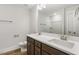 Bathroom featuring a double sink vanity and shower with a white tiled tub at 55 Browning Mill Dr, Wendell, NC 27591