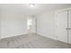 Bright bedroom featuring neutral carpet, white walls, closet and open doorway at 55 Browning Mill Dr, Wendell, NC 27591