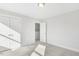 Bright bedroom featuring neutral carpet, white walls, and large closet doors at 55 Browning Mill Dr, Wendell, NC 27591
