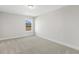 Bedroom with neutral walls and carpet, and window showcasing the view outside at 55 Browning Mill Dr, Wendell, NC 27591