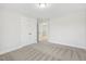 Bright bedroom featuring neutral carpet, white walls, closet and open doorway at 55 Browning Mill Dr, Wendell, NC 27591