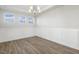 Dining room featuring wood floors, decorative wainscoting, and a modern chandelier fixture at 55 Browning Mill Dr, Wendell, NC 27591