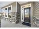 Inviting front entry featuring a modern glass door, stone accents, and ample natural light at 55 Browning Mill Dr, Wendell, NC 27591