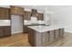 Spacious kitchen featuring an island with seating and undermount storage, custom cabinets, and modern appliances at 55 Browning Mill Dr, Wendell, NC 27591