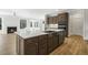 Spacious kitchen featuring a large island with a sink, custom cabinets, and stainless steel appliances at 55 Browning Mill Dr, Wendell, NC 27591