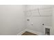 Functional laundry room with wire shelving and connections for a washer and dryer at 55 Browning Mill Dr, Wendell, NC 27591