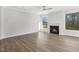 Spacious living room with hardwood flooring, a fireplace, recessed lighting, and large windows, providing natural light at 55 Browning Mill Dr, Wendell, NC 27591