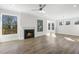 Light-filled living room featuring a fireplace, hardwood floors, and access to an outdoor deck at 55 Browning Mill Dr, Wendell, NC 27591