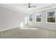 Spacious main bedroom showcasing natural light, a tray ceiling, and plush carpet flooring at 55 Browning Mill Dr, Wendell, NC 27591