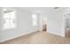 Bright bedroom with light wood flooring and natural light, leading to an en-suite bathroom at 11548 Helmond Way # 120, Raleigh, NC 27617