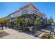Outdoor beer garden featuring a covered seating area, lush greenery, and a lively atmosphere at 11548 Helmond Way # 120, Raleigh, NC 27617