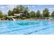 Resort-style community pool area featuring a slide, lounge chairs, and ample space for relaxation at 11548 Helmond Way # 120, Raleigh, NC 27617