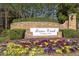 Welcoming entrance sign to Brier Creek Country Club with colorful flowers enhancing the community's appeal at 11548 Helmond Way # 120, Raleigh, NC 27617