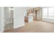 Open floor plan featuring a modern kitchen with an island and a nearby powder room, all showcasing light wood flooring at 11548 Helmond Way # 120, Raleigh, NC 27617
