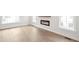 Bright living room featuring light wood flooring, a modern fireplace, and abundant natural light from large windows at 11548 Helmond Way # 120, Raleigh, NC 27617