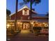 Charming two-story restaurant with outdoor seating, manicured landscaping, and a welcoming entrance at 11548 Helmond Way # 120, Raleigh, NC 27617
