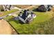 Aerial view of backyard showing lush green lawn and a screened-in porch, surrounded by mature trees at 148 Hook Dr # 7, Fuquay Varina, NC 27526