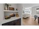 Stylish bar area with dark cabinets, white countertop and decorative shelving near a bright living room at 148 Hook Dr # 7, Fuquay Varina, NC 27526