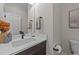 Stylish powder room with a modern vanity, elegant mirror, and neutral decor at 148 Hook Dr # 7, Fuquay Varina, NC 27526