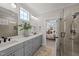 Bathroom featuring dual sinks, walk-in shower, and doorway to the bedroom at 148 Hook Dr # 7, Fuquay Varina, NC 27526