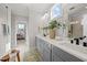 Bright bathroom featuring dual sinks, a large mirror, a walk-in shower, and stylish decor at 148 Hook Dr # 7, Fuquay Varina, NC 27526