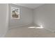 Empty bedroom features neutral carpet, a large window, and ample natural light at 148 Hook Dr # 7, Fuquay Varina, NC 27526