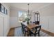 Bright dining room featuring a wooden table, chandelier, large window with a view, and stylish decor at 148 Hook Dr # 7, Fuquay Varina, NC 27526