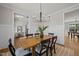 Dining area featuring a wooden table, chandelier, paneled walls, and an open doorway at 148 Hook Dr # 7, Fuquay Varina, NC 27526