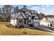 Charming two-story home with stone and siding exterior, lush lawn, and mature trees at 148 Hook Dr # 7, Fuquay Varina, NC 27526