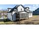 Back exterior showcasing a screened porch with black trim and white siding at 148 Hook Dr # 7, Fuquay Varina, NC 27526