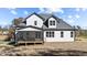 Exterior view of a home featuring a screened porch, white siding, and a dark roof at 148 Hook Dr # 7, Fuquay Varina, NC 27526