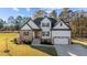Beautiful two-story home featuring stone accents, white siding, and a well-manicured lawn at 148 Hook Dr # 7, Fuquay Varina, NC 27526